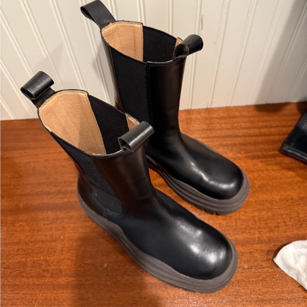 Women’s black leather lug ankle boots